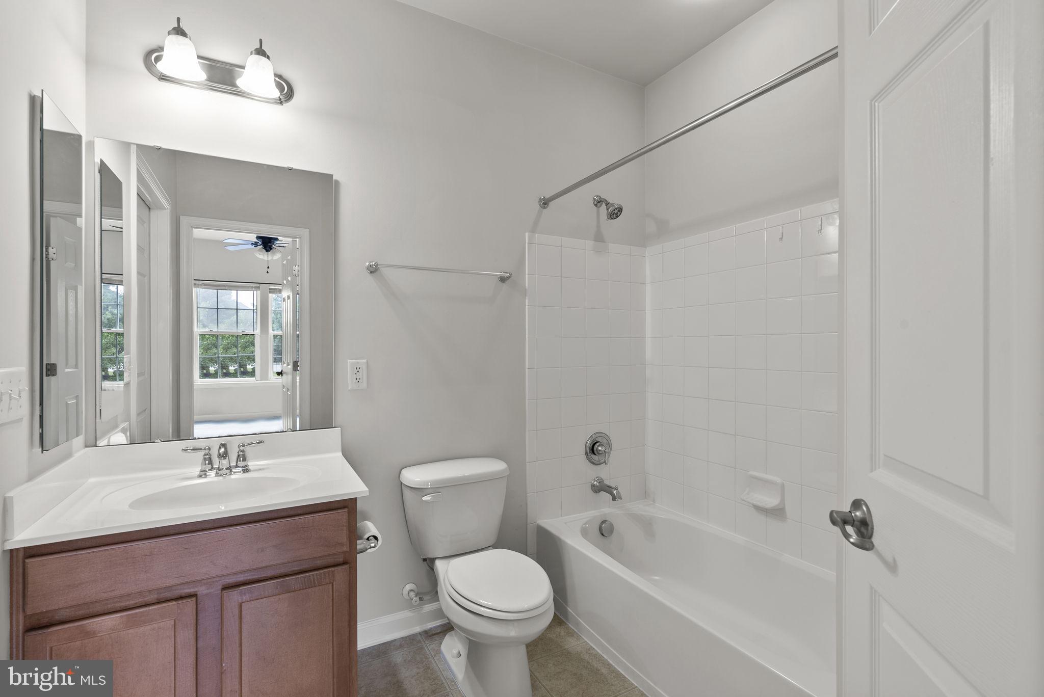 1622 Hardwick Court, Unit 201 Hanover, MD 21076 - Photo 26 of 42 a bathroom with a sink toilet a mirror and shower