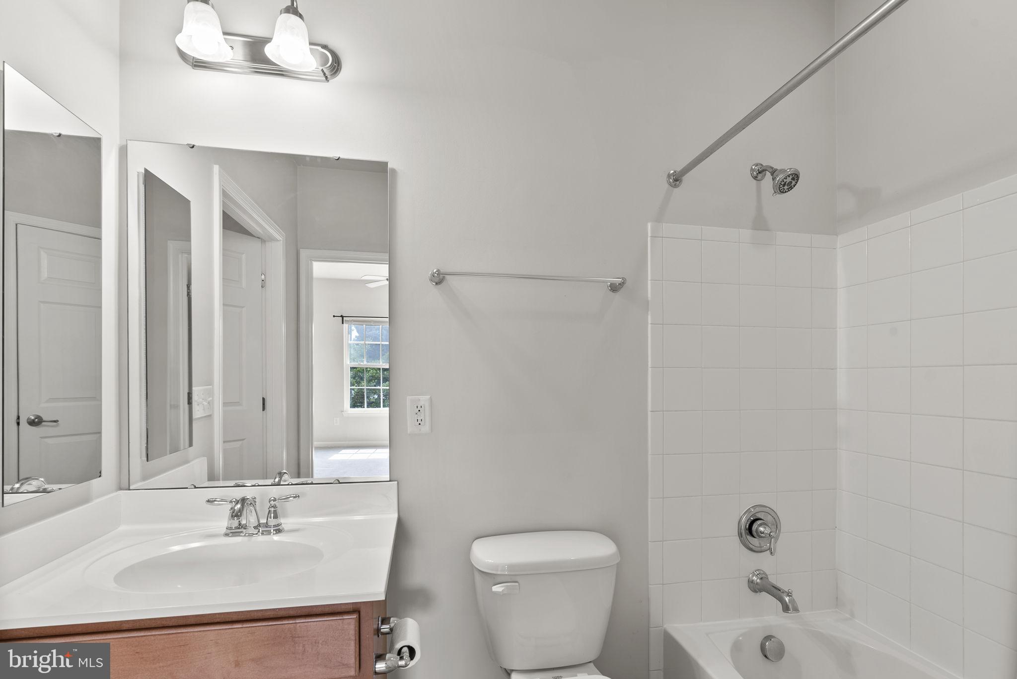 1622 Hardwick Court, Unit 201 Hanover, MD 21076 - Photo 29 of 42 a bathroom with a sink a toilet and shower