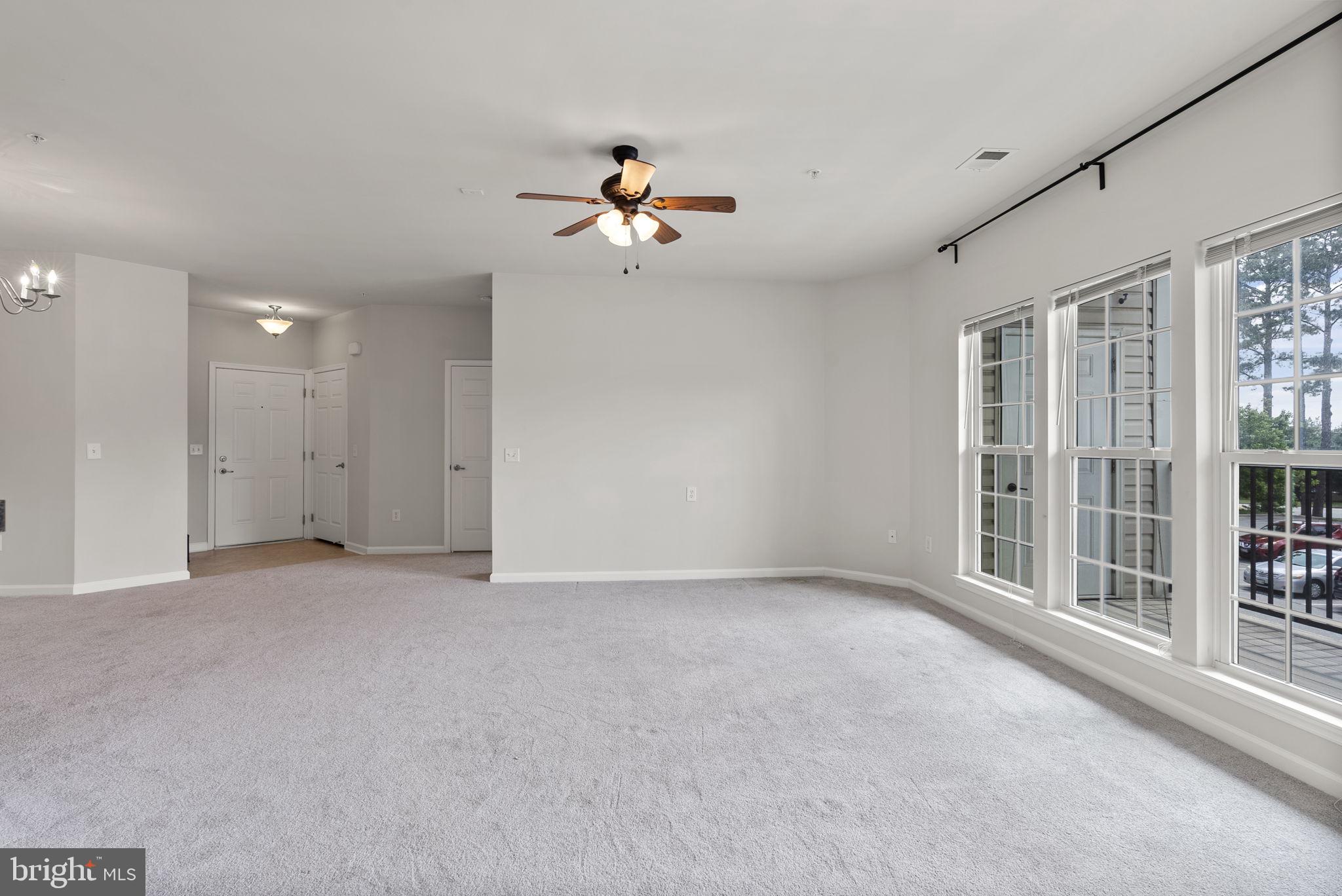 1622 Hardwick Court, Unit 201 Hanover, MD 21076 - Photo 30 of 42 an empty room with chandelier fan and windows