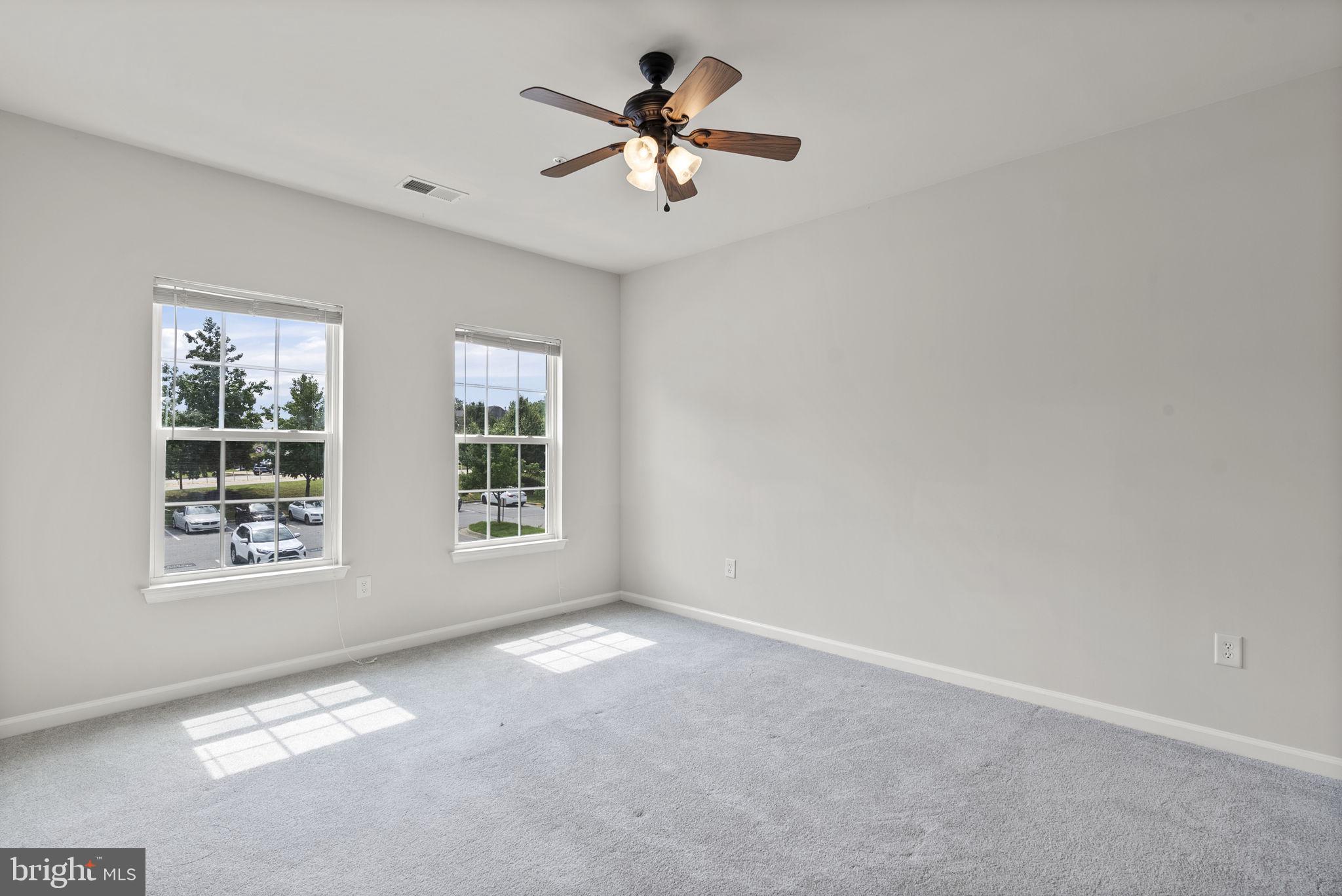 1622 Hardwick Court, Unit 201 Hanover, MD 21076 - Photo 31 of 42 an empty room with fan and windows