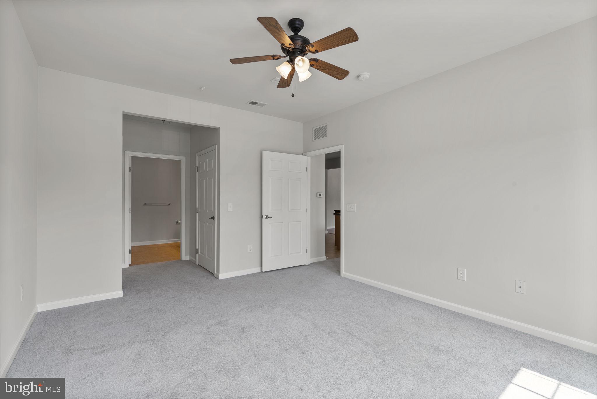 1622 Hardwick Court, Unit 201 Hanover, MD 21076 - Photo 33 of 42 a view of an empty room with a ceiling fan