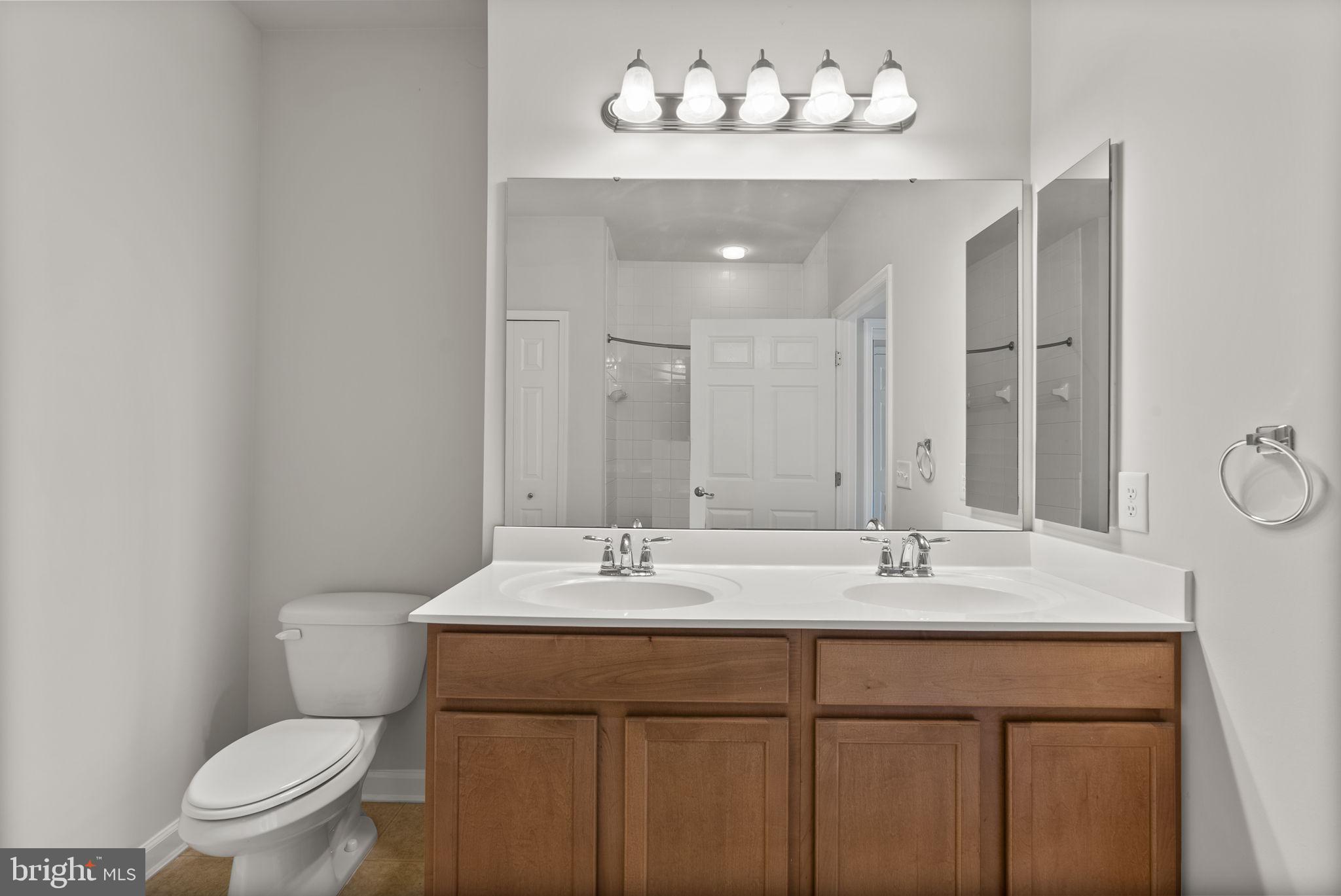 1622 Hardwick Court, Unit 201 Hanover, MD 21076 - Photo 39 of 42 a bathroom with a sink vanity mirror and toilet