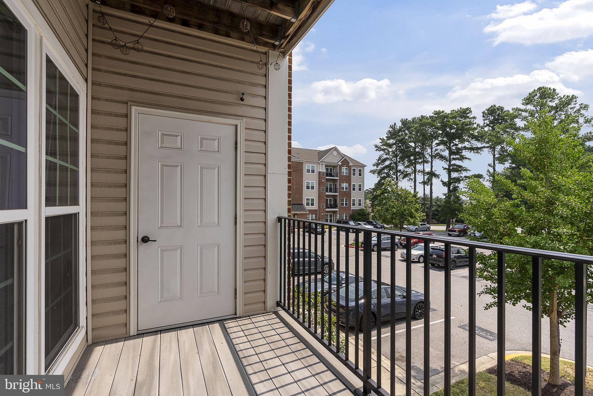 1622 Hardwick Court, Unit 201 Hanover, MD 21076 - Photo 42 of 42 a view of a balcony with wooden floor and fence