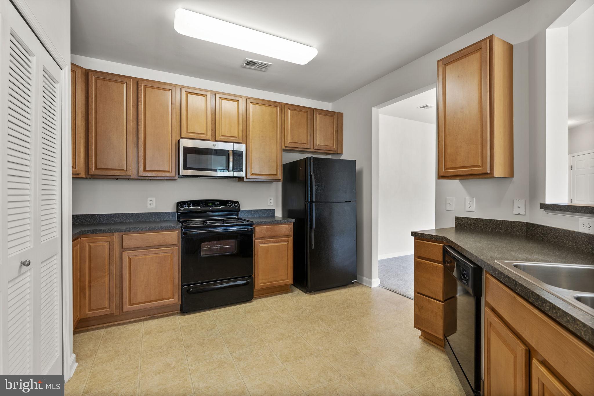 1622 Hardwick Court, Unit 201 Hanover, MD 21076 - Photo 8 of 42 a kitchen with a sink stove and refrigerator
