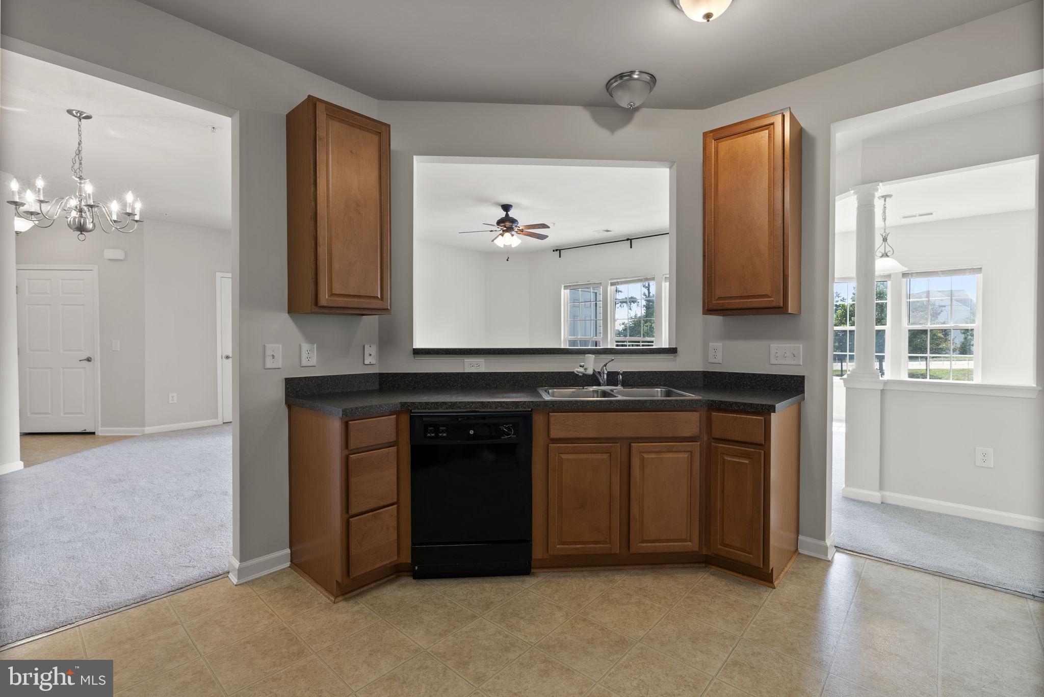 1622 Hardwick Court, Unit 201 Hanover, MD 21076 - Photo 10 of 42 a kitchen with a sink and a mirror