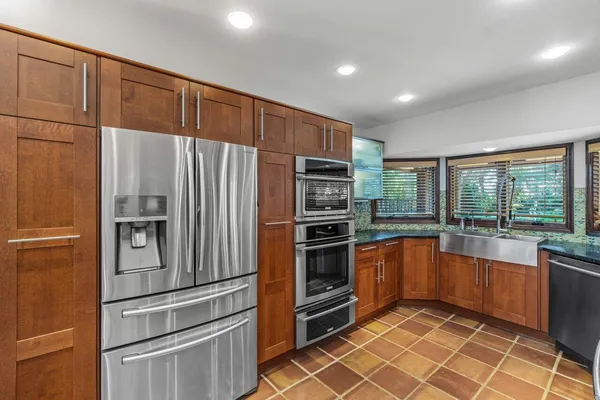 a large kitchen with granite countertop lots of counter top space
