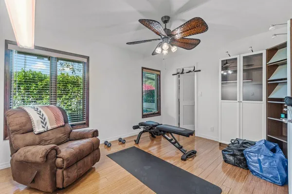 a room with gym equipment and a large mirror