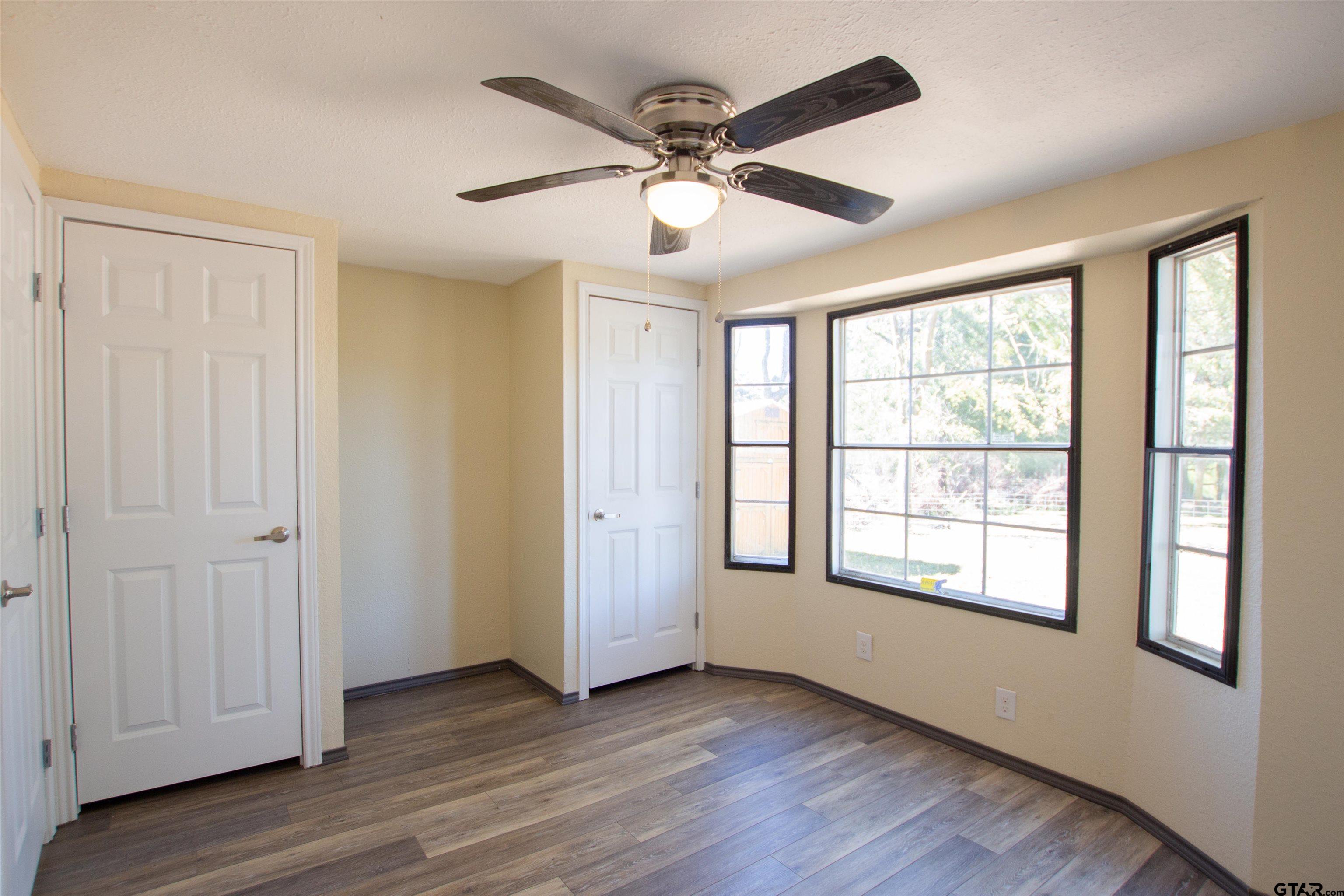 22908 Shell Shore Drive Bullard, TX 75757 - Photo 14 of 20 a view of an empty room with wooden floor and a window