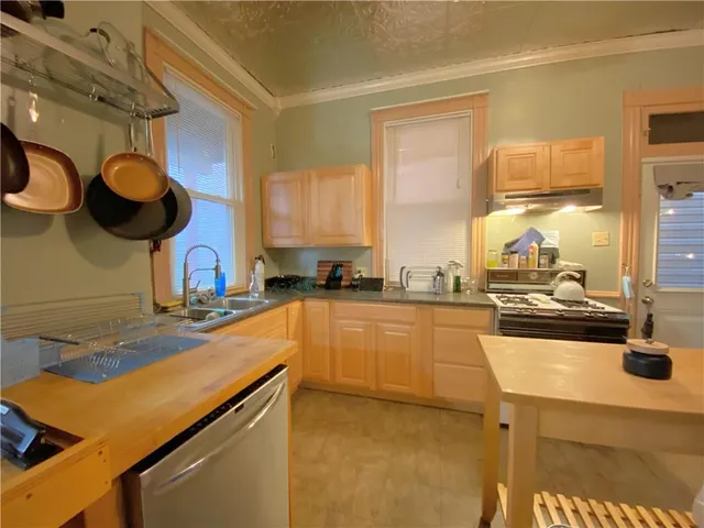 a kitchen with a sink appliances and cabinets