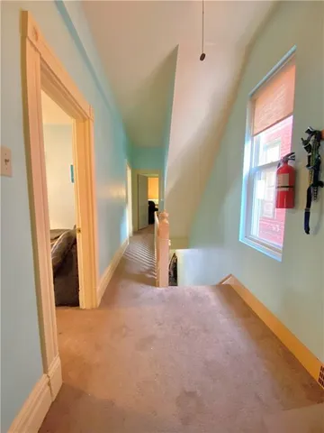 a view of a big room with windows and chandelier