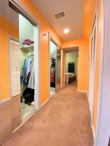 a view of hallway with furniture and a window