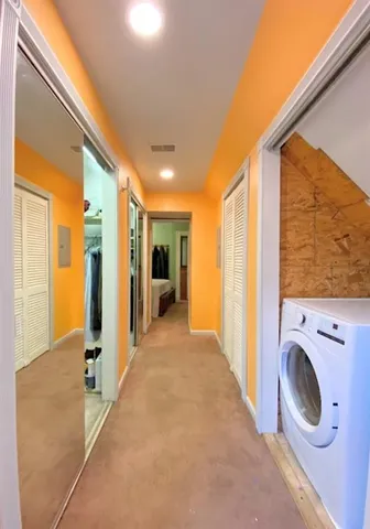 a view of a hallway with washer and dryer
