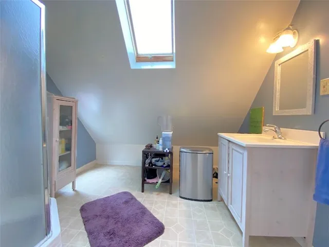 a spacious bathroom with a sink mirror and vanity