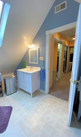 a view of a room with wooden floor and furniture