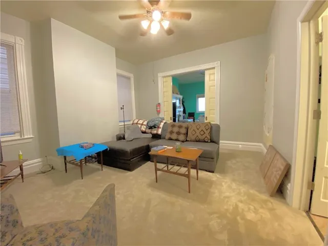 a living room with furniture and a chandelier