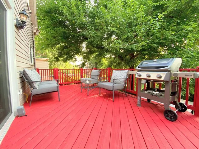 a view of balcony with seating space and wooden floor