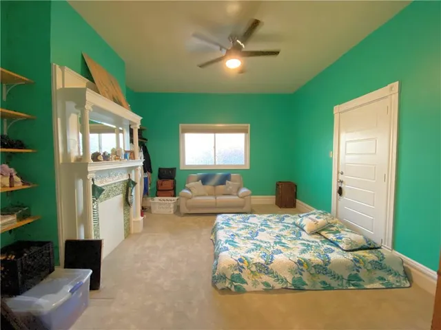 a bedroom with furniture and a large window