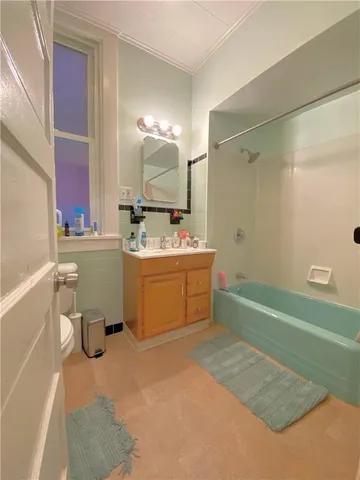 a bathroom with a sink mirror toilet and bathtub