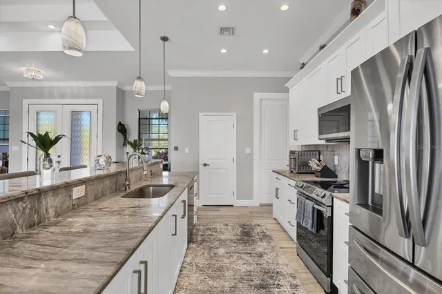 a large kitchen with a table and chairs