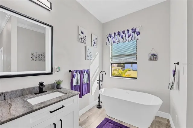 a bathroom with a granite countertop sink a toilet and shower