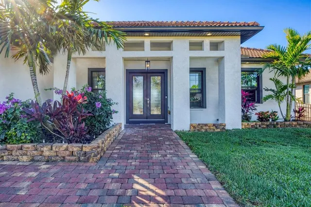 a front view of a house with plants