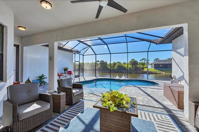 a view of a backyard with table and chairs under an umbrella