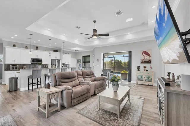 a living room with lots of furniture and a chandelier