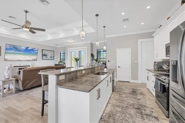 a kitchen with stainless steel appliances granite countertop a sink stove and refrigerator