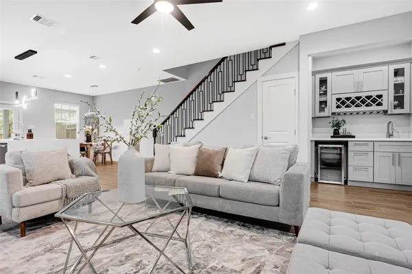 a living room with furniture and view of kitchen