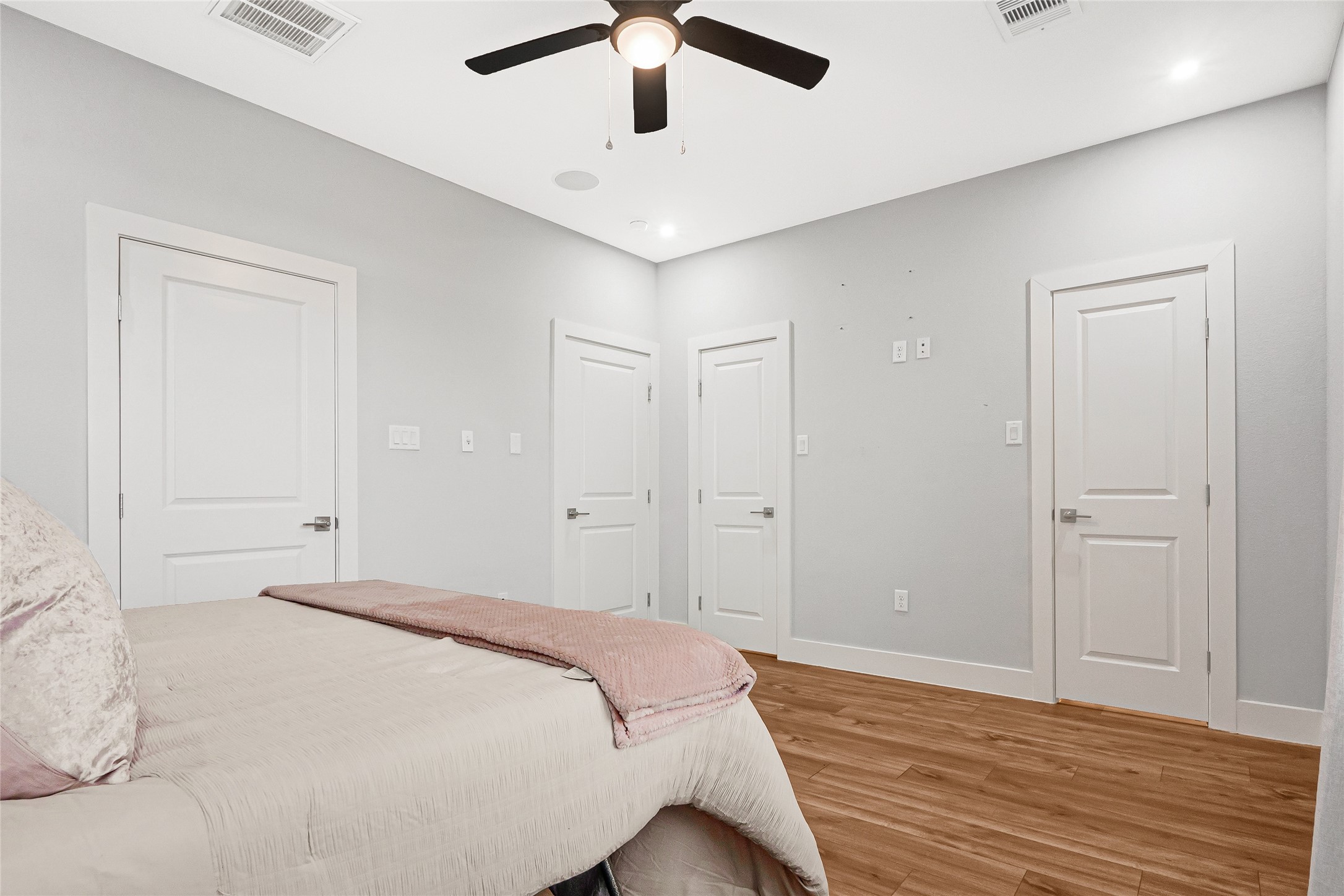 10021 Alfred Lane, Unit A Houston, TX 77041 - Photo 16 of 29 a bedroom with a large bed and wooden floor