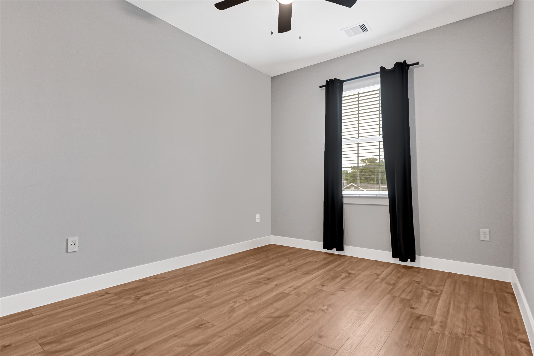 10021 Alfred Lane, Unit A Houston, TX 77041 - Photo 25 of 29 a view of an empty room with wooden floor and a window