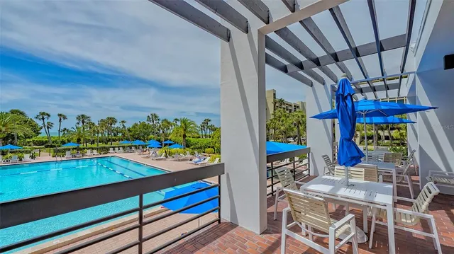 a view of a swimming pool with an outdoor space and seating area