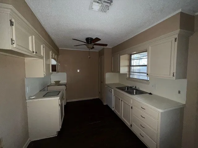 a kitchen with a sink stove and cabinets