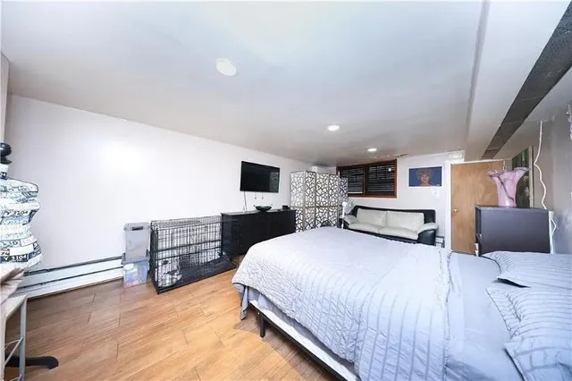 a bed room with a bed and a television