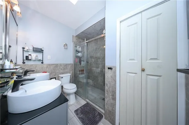 a kitchen with stainless steel appliances granite countertop a sink a stove and a refrigerator