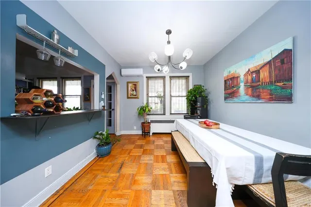 a living room with patio furniture and a chandelier