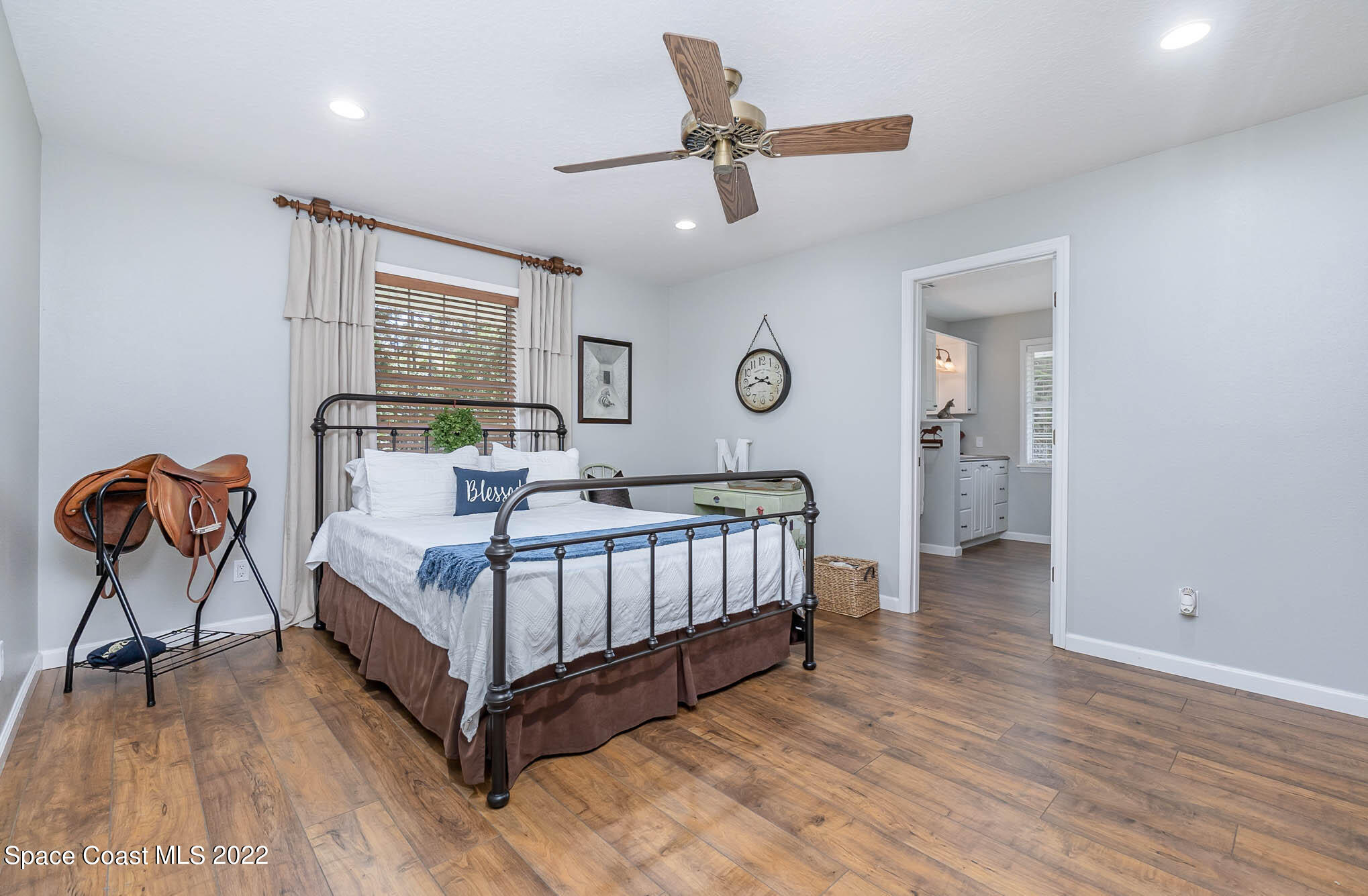 3895 Corey Road Malabar, FL 32950 - Photo 11 of 21 a bedroom with a bed and a chandelier