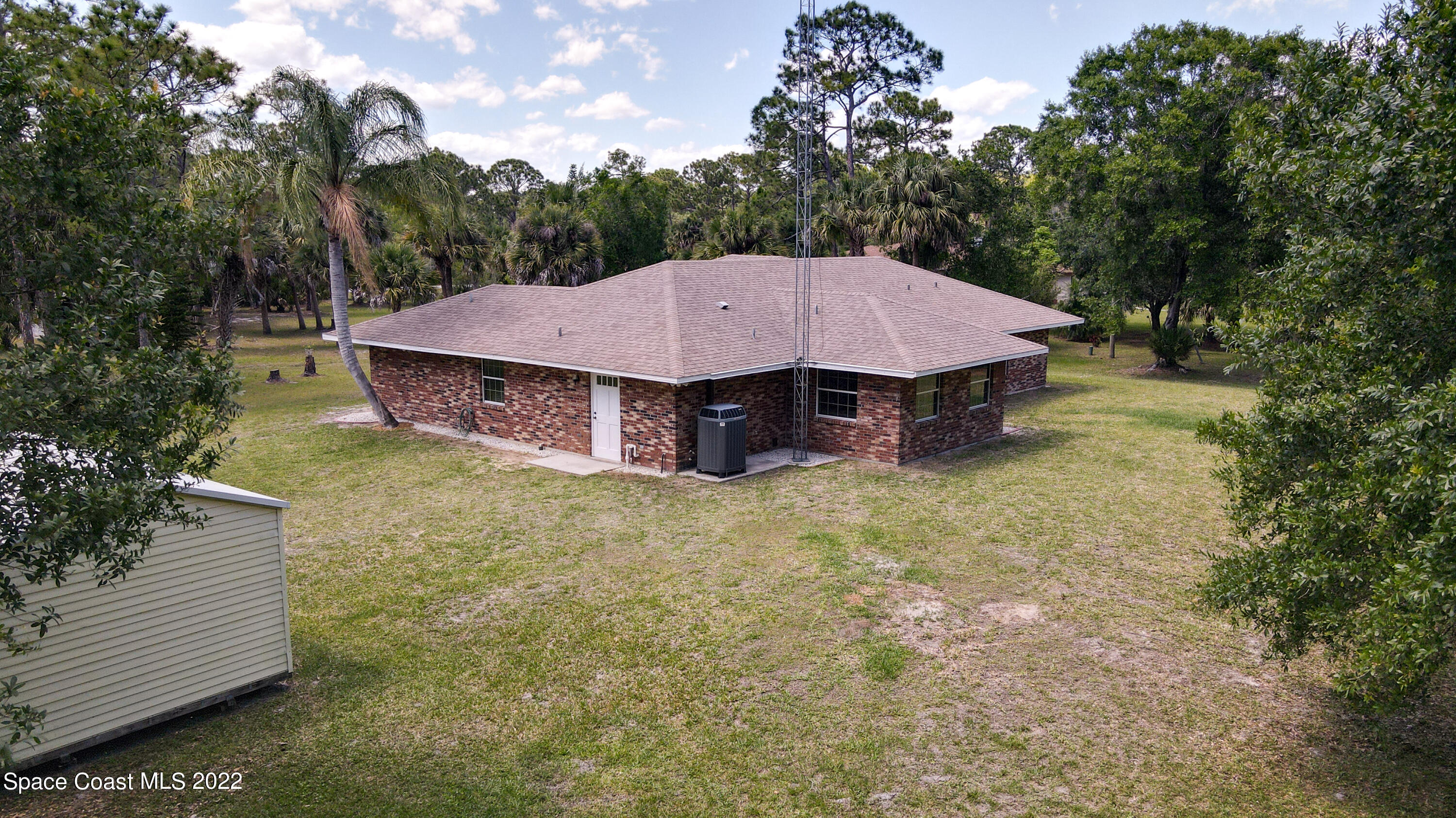 3895 Corey Road Malabar, FL 32950 - Photo 16 of 21 a view of a house with a yard and tree s