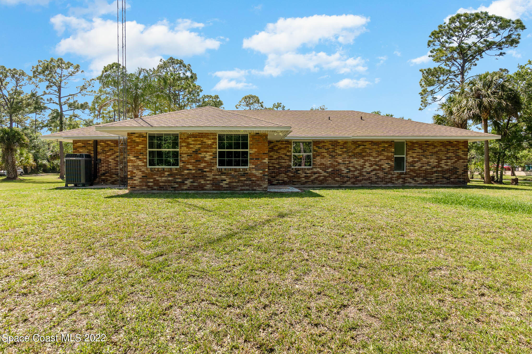 3895 Corey Road Malabar, FL 32950 - Photo 17 of 21 a front view of house with yard and trees in the background