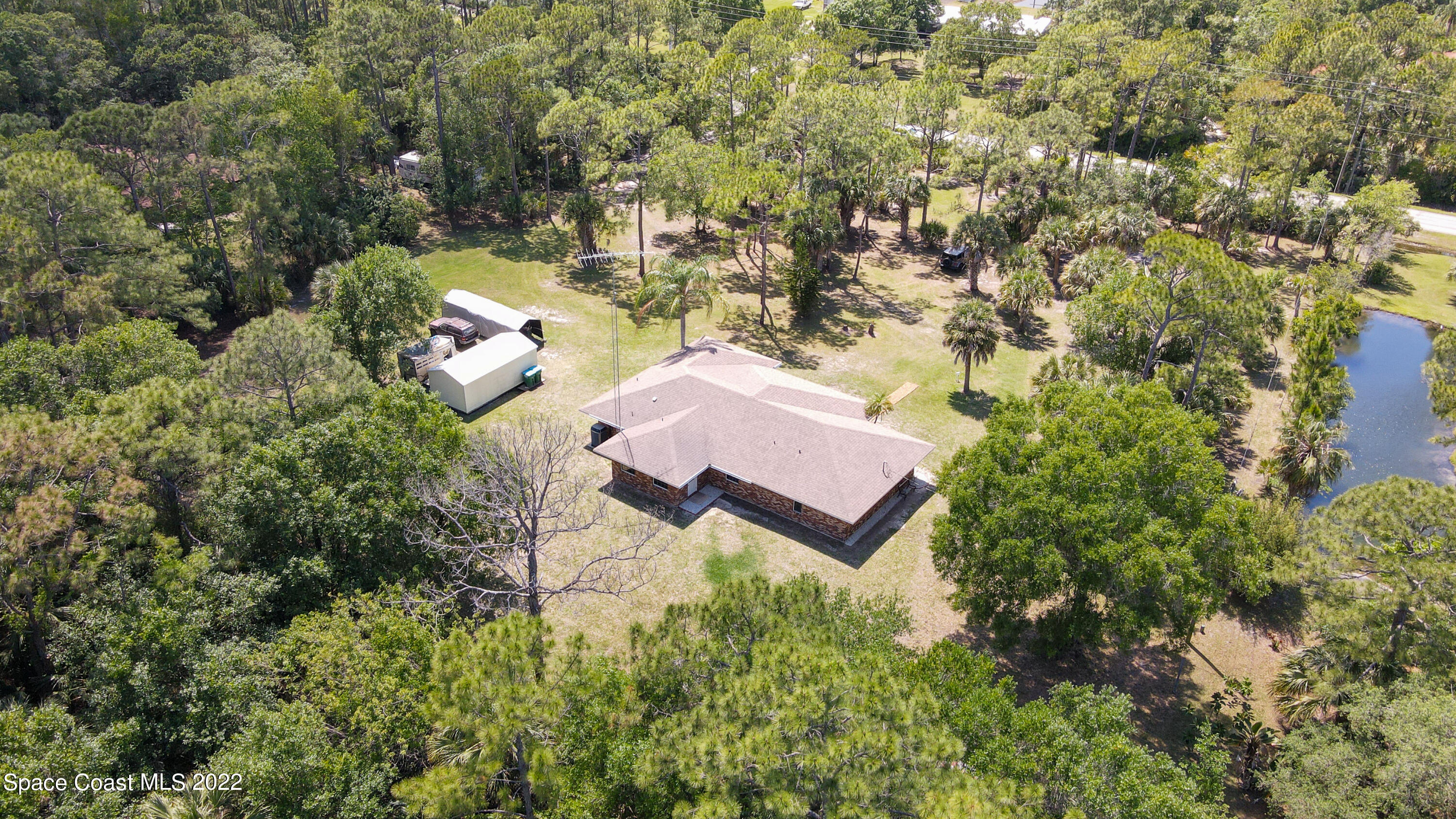 3895 Corey Road Malabar, FL 32950 - Photo 20 of 21 an aerial view of a house with yard and outdoor seating