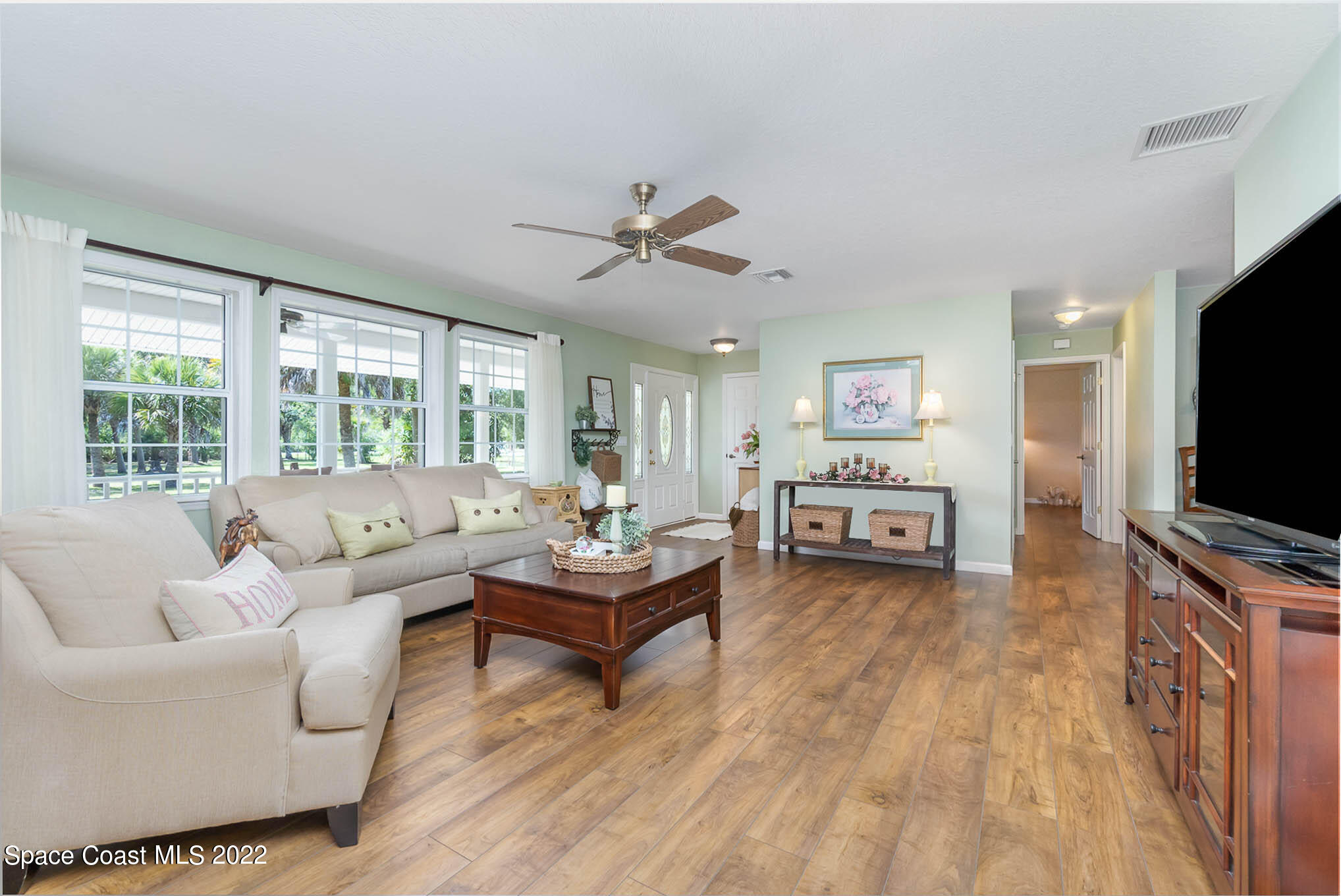 3895 Corey Road Malabar, FL 32950 - Photo 3 of 21 a living room with furniture and a flat screen tv