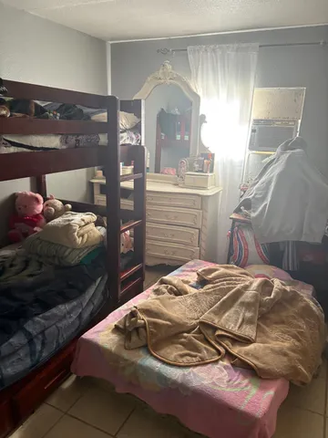 a bedroom with a bed and mirror