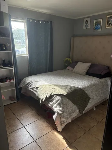 a bedroom with a bed and window