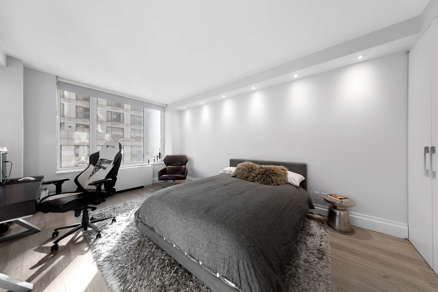 220 Riverside Boulevard, Unit 4H Manhattan, NY 10069 - Photo 12 of 15 a bed room with two beds and a chair