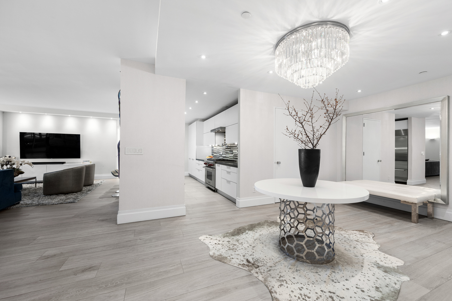 220 Riverside Boulevard, Unit 4H Manhattan, NY 10069 - Photo 2 of 15 a living room with furniture a flat screen tv and a chandelier