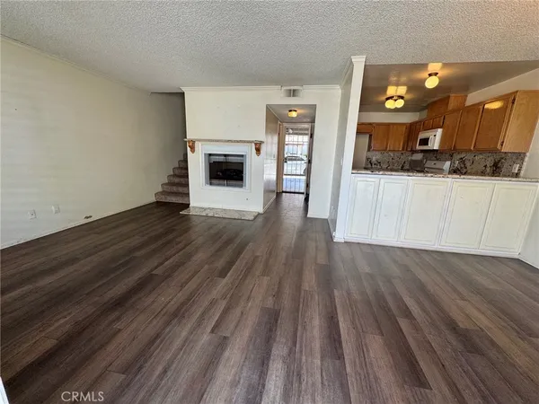 a view of kitchen with furniture and wooden floor