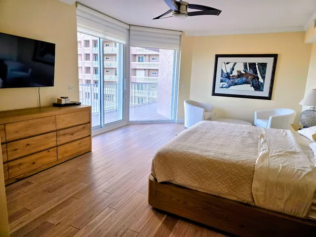 a bedroom with a bed and a painting on the wall