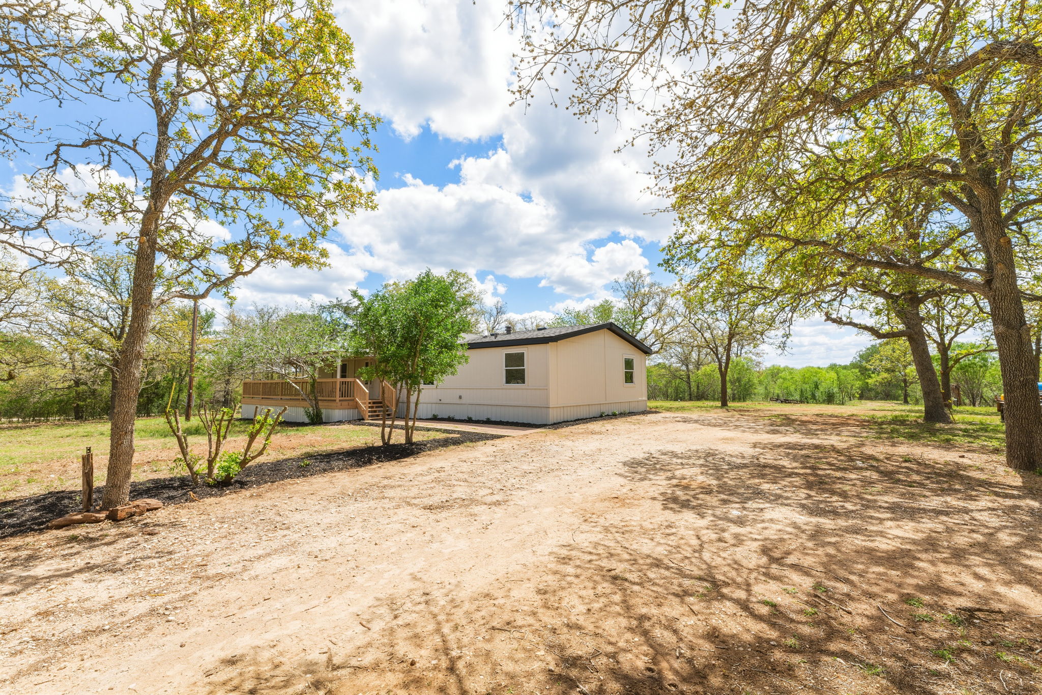 340 Red Hawk Drive Dale, TX 78616 - Photo 11 of 38 View of front of home featuring dirt driveway and a deck