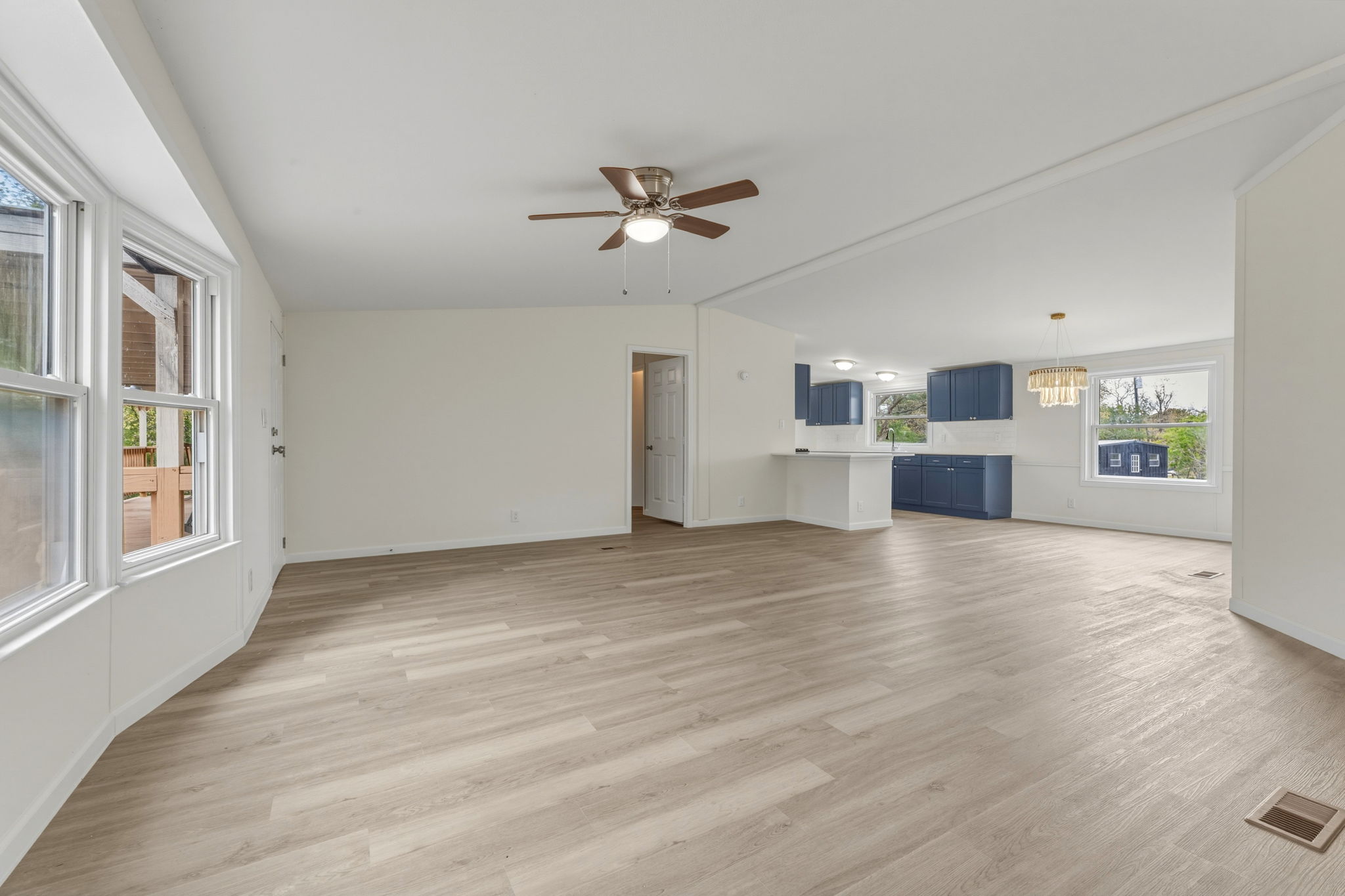 340 Red Hawk Drive Dale, TX 78616 - Photo 18 of 39 Living room featuring water proof vinyl plank floors, ceiling fan, and vaulted ceiling