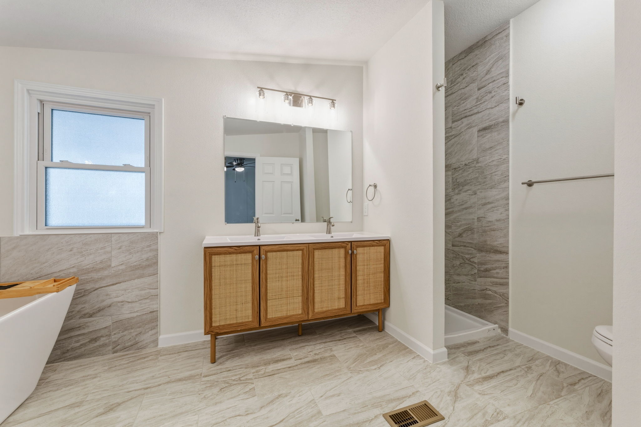 340 Red Hawk Drive Dale, TX 78616 - Photo 19 of 38 Full bath featuring double vanity, a soaking tub, and a tile shower